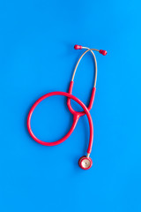 Stethoscope for family doctor set on blue background top view space for text