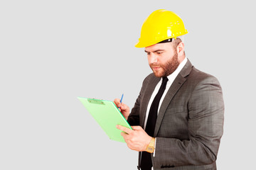 young civil engineer working at office with suit and helmet