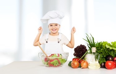 Portrait of adorable little girl preparing healthy food at kitchen