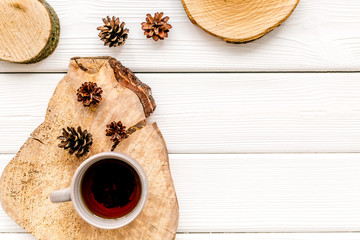 coffee on wooden sawcut and pine cone pattern for blog on white background top view mockup