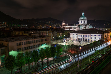 Fototapeta na wymiar the Italian city of Como shot in a panorama from above with lights, traffic, buildings and the cathedral