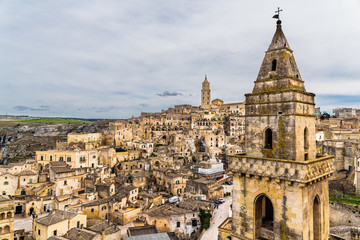 Fototapeta na wymiar Long panoramic views of the rocky old town of Matera with its stone roofs.