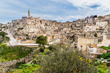 Naklejka premium Long panoramic views of the rocky old town of Matera with its stone roofs.
