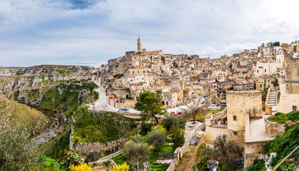 Long panoramic views of the rocky old town of Matera with its stone roofs.