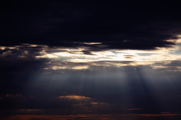 black clouds and sun rays