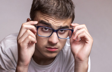 Teenager wearing glasses for sight. Eyesight problems. Health protection concept