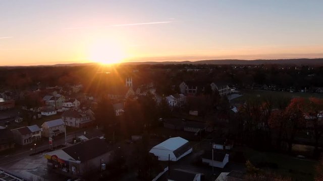 Aerial sunrise slow pull back over Annville, Lebanon County, Pennsylvania. Concept: daybreak, small town, first light.