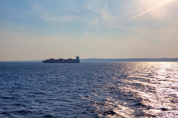 cargo ship on the skyline of blue sea 