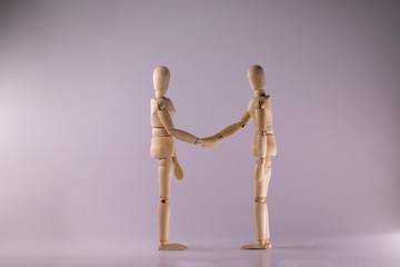 Two dummy shake hands. Isolated on white background 