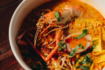 The instant noodles, Tom Yum Goong Food, Lobster shrimp (giant freshwater prawn) and herbs, spices, lemon, various vegetables, on dark wood background,