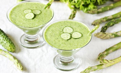 soup puree from avocado, asparagus and cucumber. Dietary detox diet. Vegetarian dish. serving soup in a glass bowl.