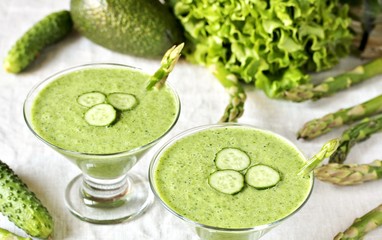 soup puree from avocado, asparagus and cucumber. Dietary detox diet. Vegetarian dish. serving soup in a glass bowl.