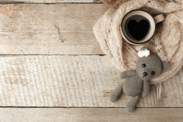 cozy winter or autumn morning at home. Hot coffee, warm blanket, ghandcrafted knitted toy-bear,...