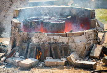 The burning furnace in local foundry of Thailand. Steel production in manual furnace.