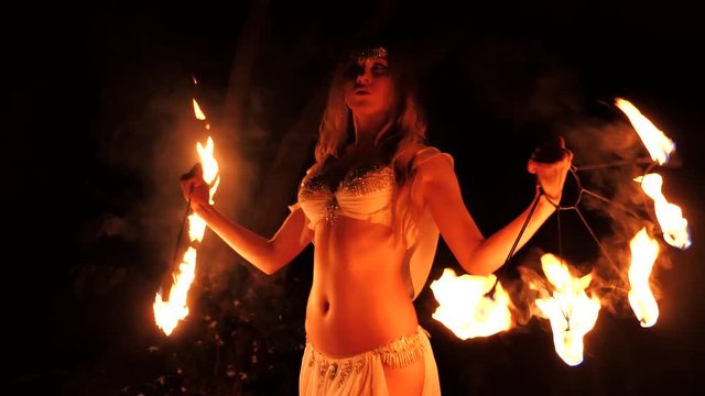 Fire woman dancing with burning fans