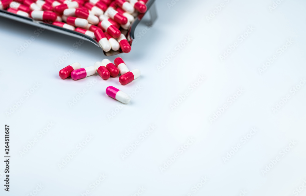 Poster pink-white and red-white capsule on white table and blurred stainless steel drug tray. love pills fo