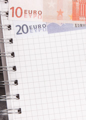 Notepad for notes and currencies euro. Place for text on sheet of paper