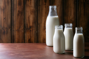 Fresh milk in different glass bottles