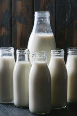 Fresh milk in different glass bottles