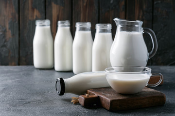 Fresh milk in different glass bottles