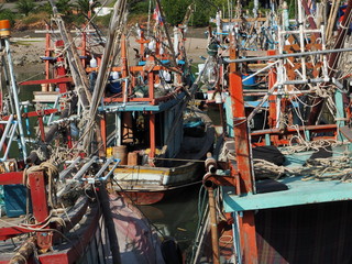 Fototapeta na wymiar Fishing boats moored in a small port in Thailand