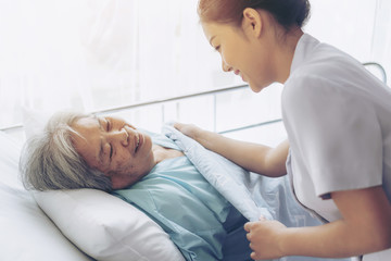 the nurses are well good taken care of elderly patients in hospital bed patients  feel happyness -...