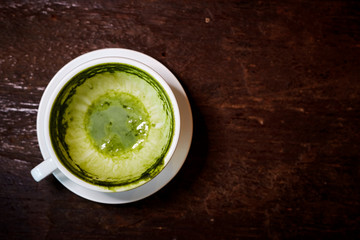 Empty white cup of matcha tea