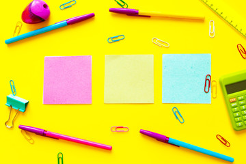 Back to school concept with space for text. Top view. Copy space. School office supplies.Creative desk with colourful stationery. Colored paper clip.School supplies on yellow background.Office desk.