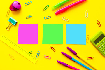 Fototapeta na wymiar Back to school concept with space for text. Top view. Copy space. School office supplies.Creative desk with colourful stationery. Colored paper clip.School supplies on yellow background.Office desk.