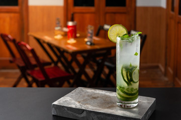 Mojito cocktail is on the bar. Space for text. Photo for the menu.