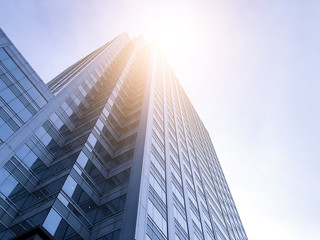 Fototapeta na wymiar Office buildings stretch up to the sky with sunlight.