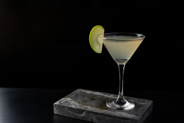 Apple Martini cocktail is on the bar. Space for text. Photo for the menu.