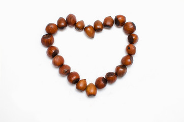 the heart is lined with hazelnut on white background, with a place for the text 