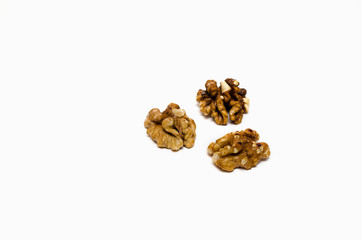 three walnuts partially out of focus on white background, with a place for the text 