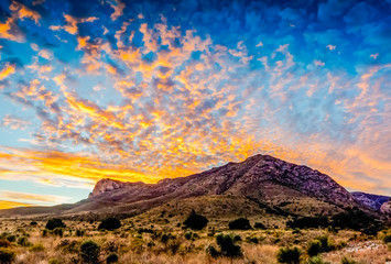 Fototapeta na wymiar Golden Cloudscape of Texas sunset on the Guadalupe Mountains.