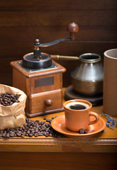cup of coffee, turka, coffee beans and a coffee grinder, croissants