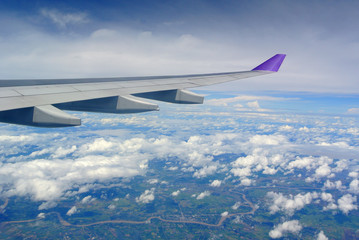 Fototapeta premium Aerial view Clouds and sky as seen through window of an aircraft