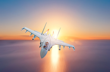 Afterburner fighter jet flies over the sea during sunset.