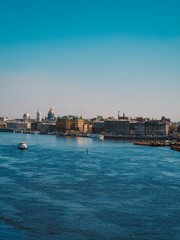 Fototapeta premium Neva river in St. Petersburg, panorama of the city, visible St. Isaac's Cathedral and port extensions
