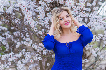 Portrait of nice woman at chiffon dress in garden, tenderness and femininity concept