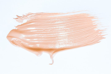 Liquid foundation smudges isolated on white background. Light  tone foundation texture for background. BB, CC cream foundation. Make-up base foundation.Professional makeup products. Top view.