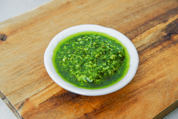 Pesto sauce on the plate. Italian cuisine.
