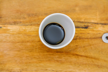 Soy sauce in a white Cup.