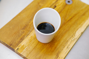 Soy sauce in a white Cup.