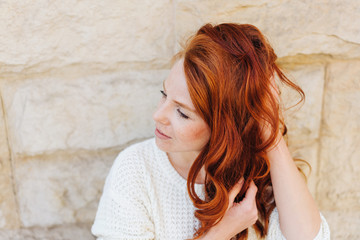 Thoughtful woman running her hand through her hair