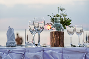 Serving for a romantic dinner on the beach at sunset.