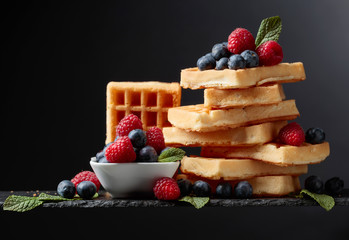 Belgian waffles with  blueberries, raspberries  and fresh mint.