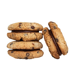 Stack of delicious italian sandwich cookies Baci di Dama (Lady's Kisses) made with hazelnut flour, chocolate chips and filled with gianduja spread isolated on white background. Piedmont speciality