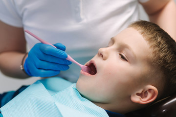 Close up of dentist examination little boy's teeth in clinic