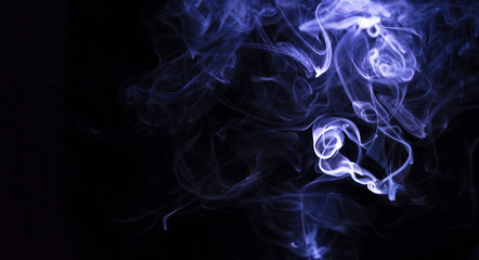 Puffs of smoke in blue on black background